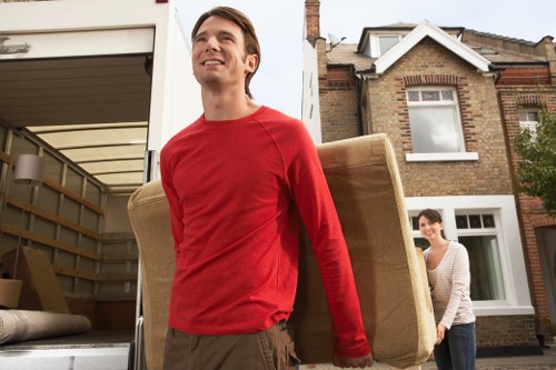 Local movers handling furniture in a Bromley property