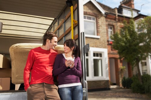 Local movers carrying furniture from a Bromley property